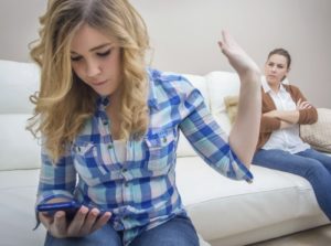 daughter on phone with mother on couch